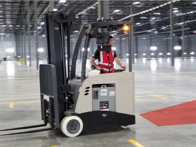 Forklift operator in a warehouse